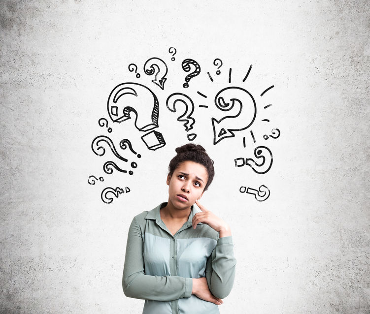 Woman standing with question marks above her head