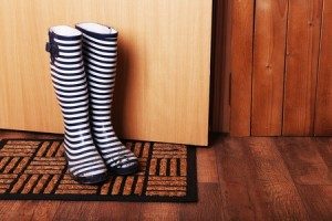 Stripped rain boots by front door