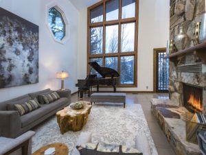Large windows with fireplace and piano